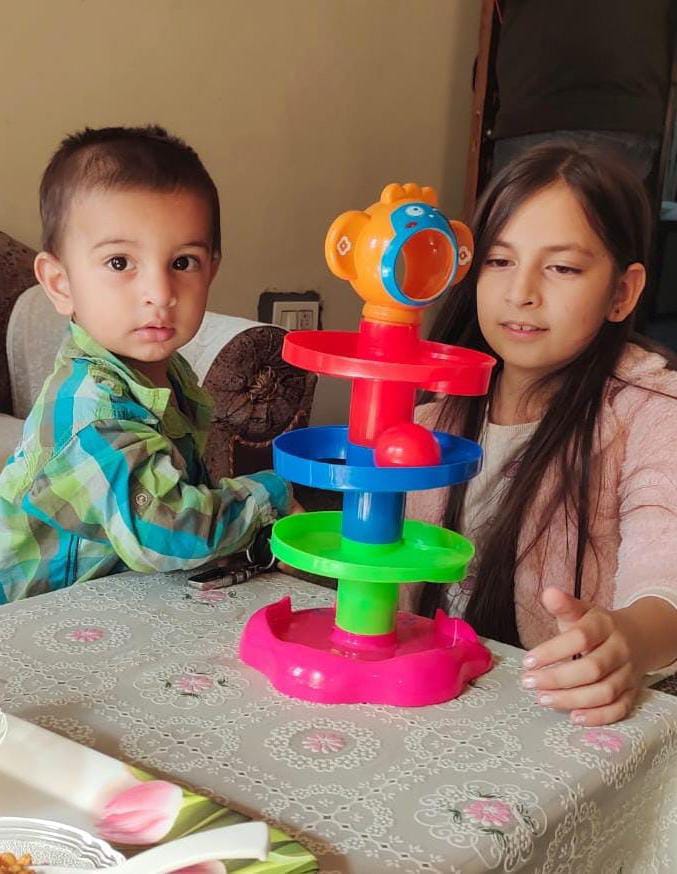 Ball drop and roll spinning tower